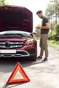 Man using phone for help on the road
